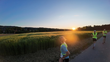 The sunset provides a stunning backdrop.