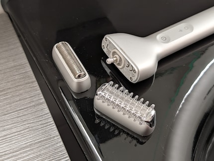 The attachments are held to the razor with magnets, allowing you to trim hair as well as shave.
