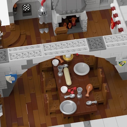 The great hall of the Norman castle with fireplace, wall decorations and a richly laid table.