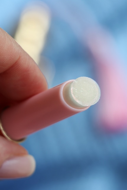 Der wachsige Balsam enthält feine, pinke Schimmerpartikel.