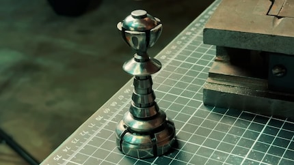 A unique piece of metal: Works by Design 3D-printed this version of its mechanical pawn and presented it to the chess club as a souvenir.