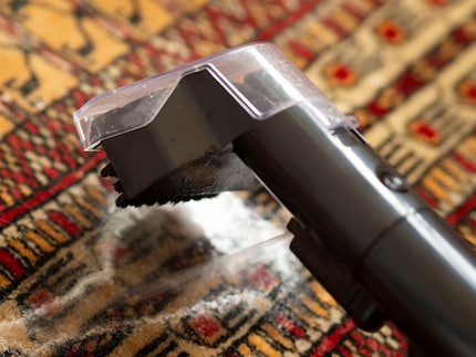 Eerst spuit ik de vlekken in met het mengsel van water en schoonmaakmiddel, ...