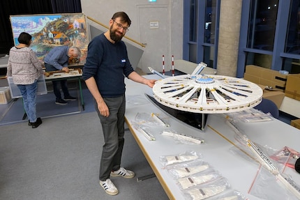 Builder Matthias Jonda presents the saucer section of his 50,000-brick Lego Enterprise under construction at the «Zusammengebaut» trade fair in Borken.