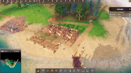 Der Start jeder Siedlung: Träger verteilen Rohstoffe, während die ersten Gebäude entstehen.