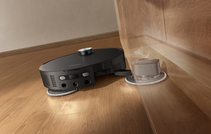 The robot hoover extends the mop far to the side.