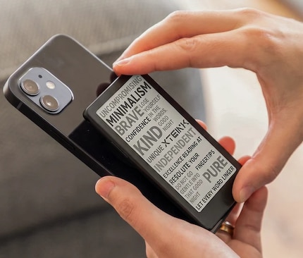 The mini e-reader attaches to the back of the smartphone much like a magnetic power bank.