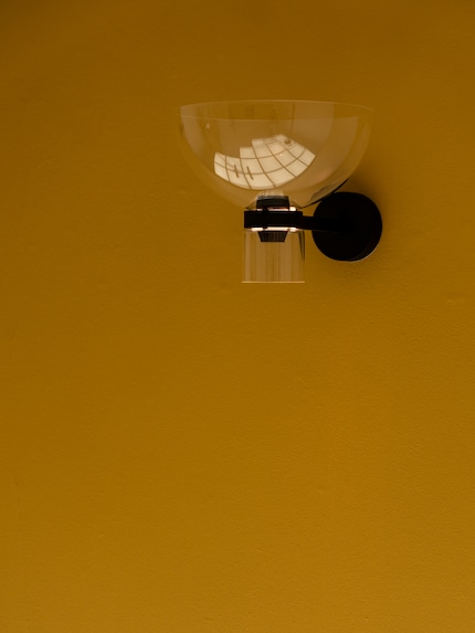 The hemispherical version casts soft light back onto the wall.